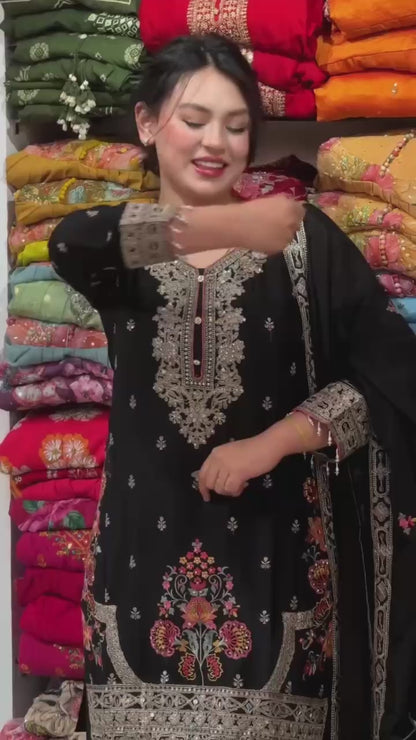 Designer black embroidered Pakistani suit with elegant neckline and matching dupatta for women.